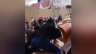 Sexy Bizarre Moment Woman TWERKS on top of coffin of his husband in front of cheering crowd