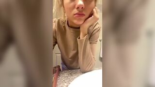 Gorgeous bored young teasing on the toilet